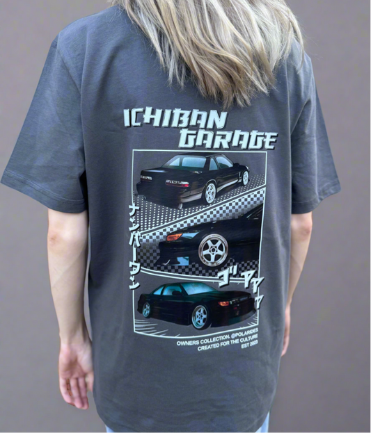 Person wearing a gray t-shirt with 'Ichiban Garage' car graphic design on a plain background